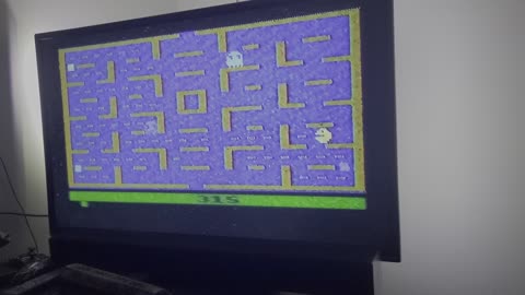 Playing pac man on old skool console HD TV