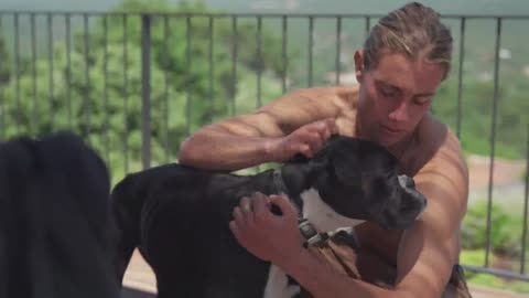 Man petting his dog on a terrace_batch