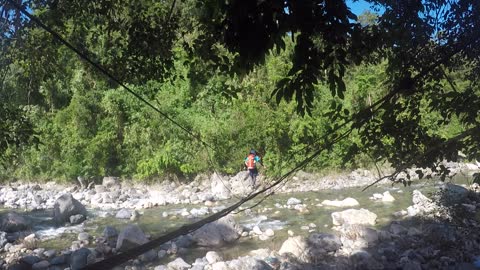 Crossing a hanging bridge.