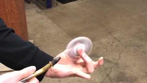 Guy uses air hose on fidget spinner