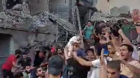 Dead baby is lifted from under the rubble in Gaza