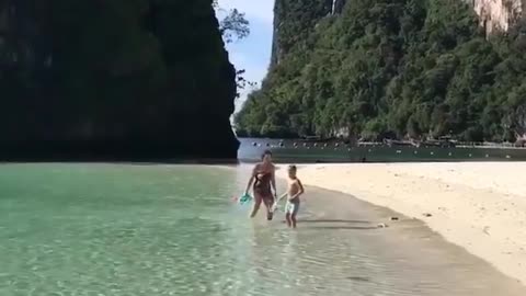 He and his mother played on the white sand beach and in the clear water.