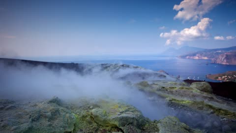 Rocky volcano while smoke comes out from below