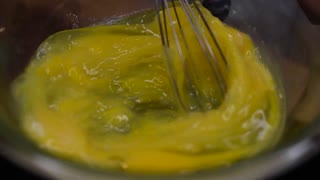 whisking eggs over boiled water