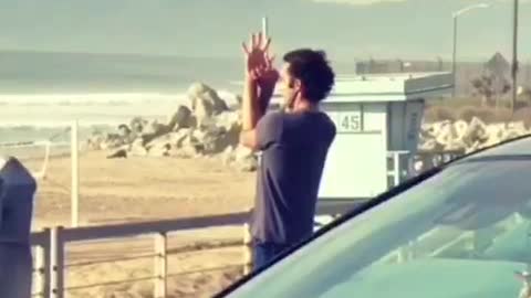 Guy does meditation poses at the beach, flute music