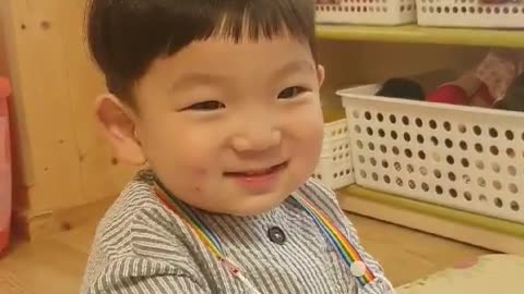 This is a video of a baby smiling brightly to the song.