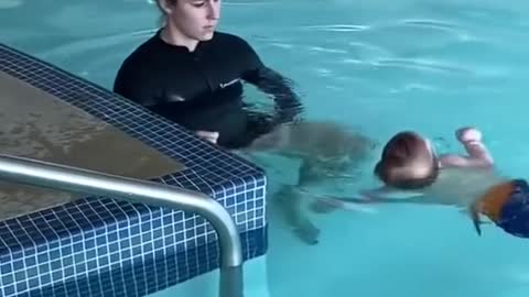 Cute baby swing in swimming pool