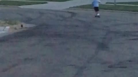 Little boy blue shirt scooter gos too fast and falls off