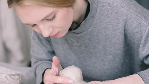 Woman making crafts on clay