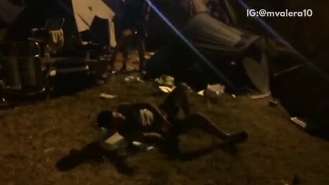 Fireworks in background guy shotguns beer and then breaks box