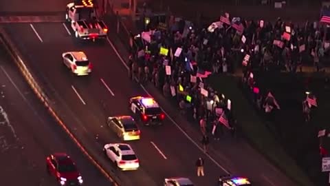 Large group of anti-covid-19 protesters protesting near the Golden Gate Bridge