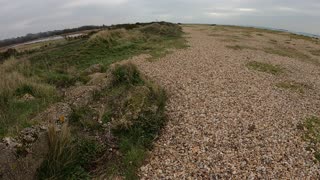 Speedlapse . Hiking on a beach.