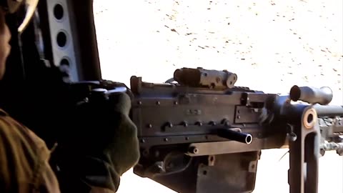 chinook-door-gunner-fires-his-machine-gun