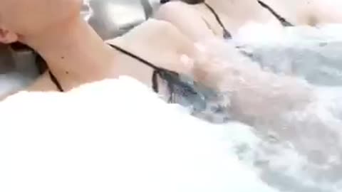 Two women enjoying and relaxing in a jacuzzi