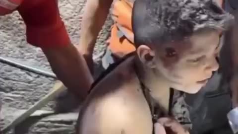 A young Palestinian boy was pulled out alive from the rubble