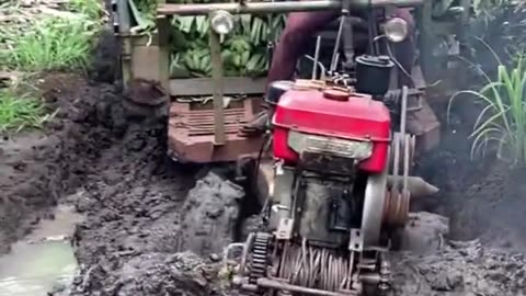 Tractor doing its work on a marshy groind