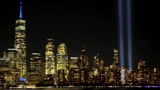 Twin blue beams mark 9/11 against New York's night sky