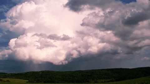 Time Lapse of Clouds with a Rainbow