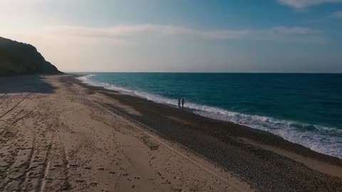 Couple walking on beach.