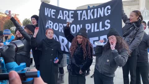 Pro-Abortion Activists Take Abortion Pills While Chanting Outside Of The Supreme Court