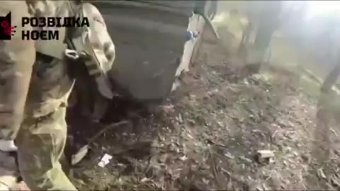 Ukrainian medics evacuate their fallen comrade from a vehicle