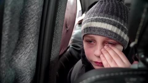 'We left our Dad in Kyiv' -little boy chokes back tears