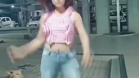 GIRL DANCES WHILE A DOG...