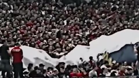 Serbian football fans stretch a huge flag of Russia at the match with Ukraine