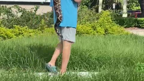 Man Taking a Snake for a Stroll