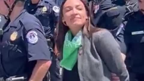 Why is AOC Pretending to be Handcuffed?