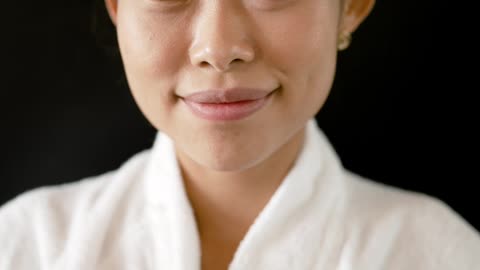 A Woman Wearing Bathrobe Smiling at Camera