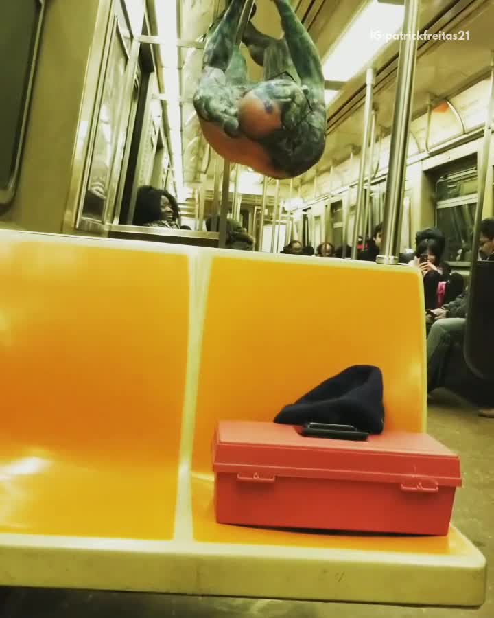 Green shirtless guy glasses hangs from subway railing