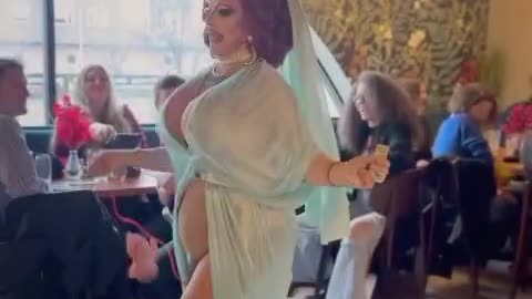 Drag queen dresses as Mary while pulling an aborted fetus out of her body and swinging it