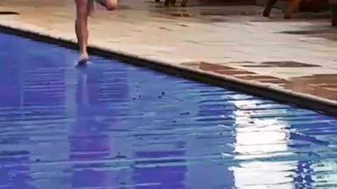 Man in red swim shorts runs on pool