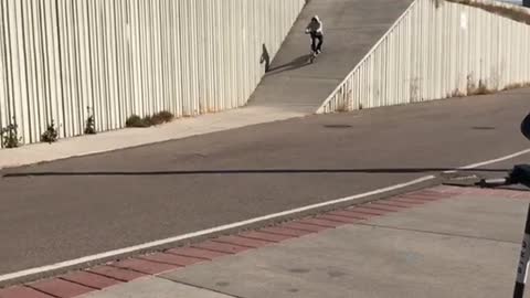 Guy on scooter goes down large ramp falls back