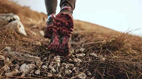 SLO MO Feet of a female runner pushing gravel