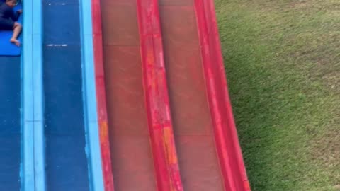 Guy Helps Boy Stuck in the Middle of Water Slide