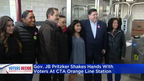 Gov. JB Pritzker shakes hands with voters at CTA Orange Line station