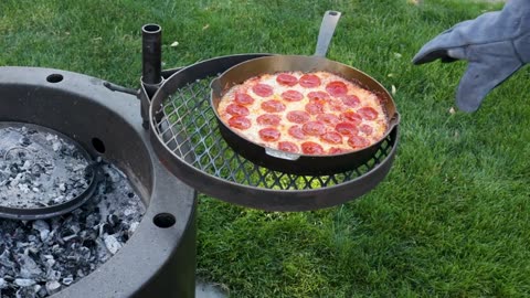 Cooking delicious pizza over an open fire