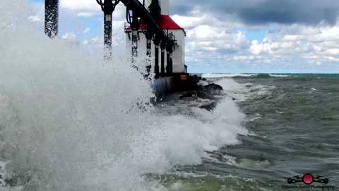 Waves Hitting Drone As They Wash Over Lighthouse & Pier 4K Drone Footage