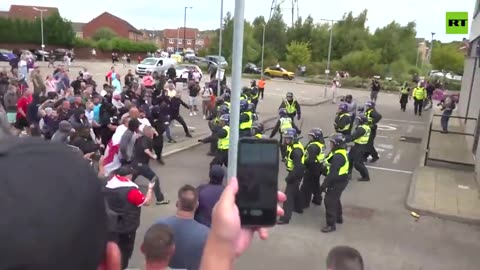 Protesters throw stones, wood planks (& apparently whatever they can find) at police officers in UK