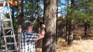 Installing brackets on a 100% cedar treehouse.