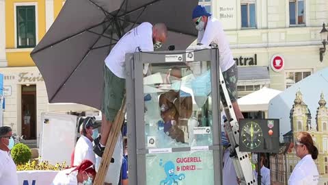 Austrian man breaks record for standing in box of ice