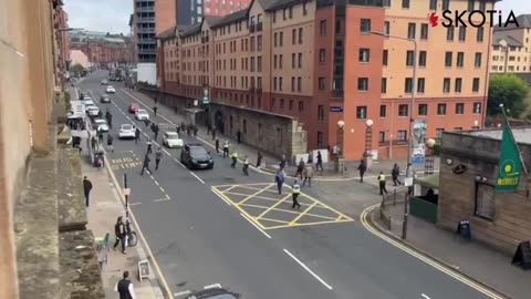 A group dressed in all black have just thrown bottles at a pub in Glasgow, tried to