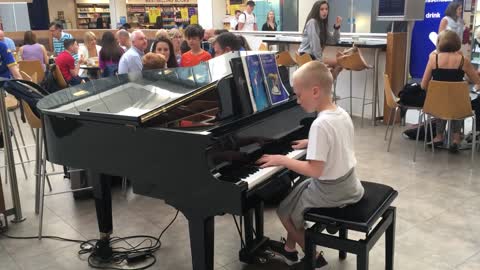 11 Years old kid playing piano at airport- the relaxed guy