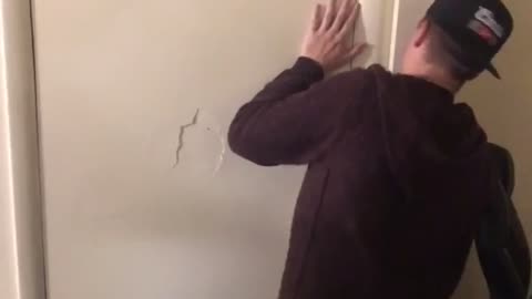 Guys block friend behind door arm punches hole through door