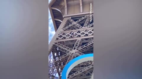 Man climbs Eiffel Tower before Olympic closing ceremony.mp4