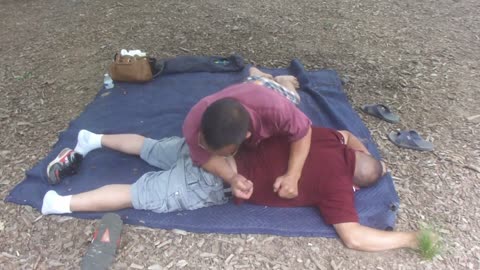 Luodong Massages Mexican Man In Red Shirt At The Park