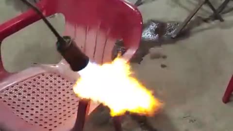 Reviving sun-faded outdoor plastic chair with a blowtorch