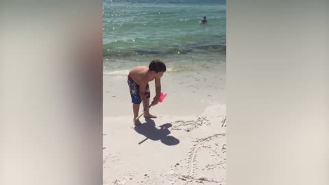 Little Boy Can’t Wait For His Mom To Check Out His Sand Masterpiece